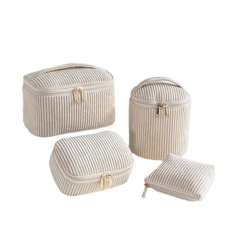 Four cube-shaped flannelette make-up bags in different colours: pink, khaki, pink dots, blue dots