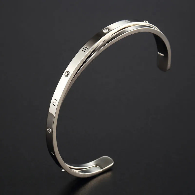 Open-ended stainless steel bracelet with inlaid zircon stones available in gold, rose, and steel colours