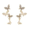Gold-coloured copper butterfly earrings with four-wing design and drop silhouette for women