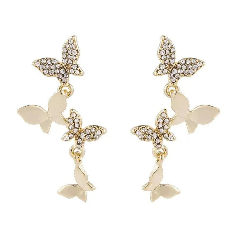 Gold-coloured copper butterfly earrings with four-wing design and drop silhouette for women