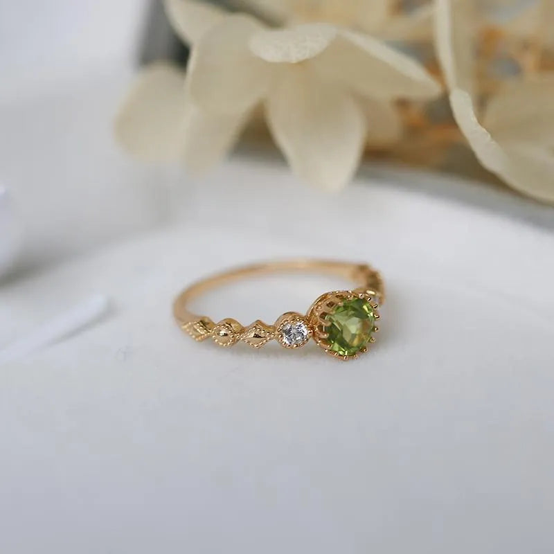 Close-up of a copper ring with a geometric quadrilateral shape and imitation peridot detail.