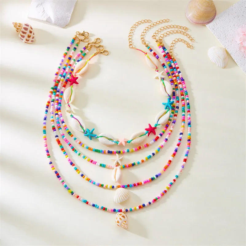 Women's multi-layer necklace set with starfish and shell bead pendants on adjustable chain