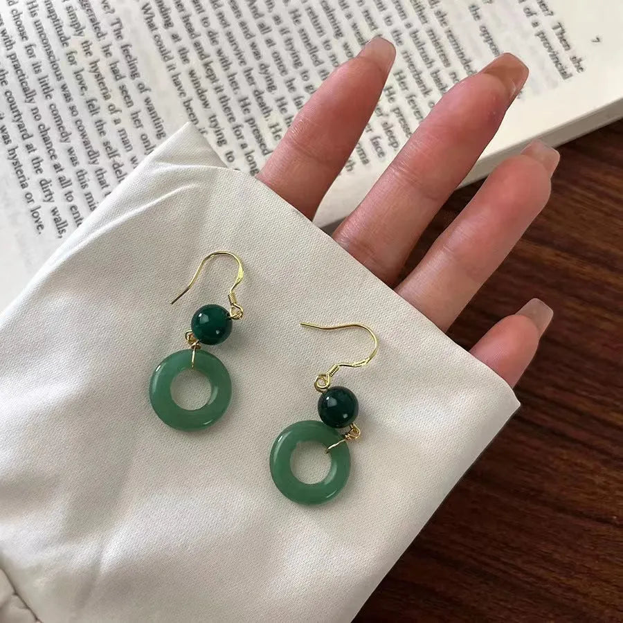 Green Chinese style peace buckle shaped earrings with geometric design and gold plating