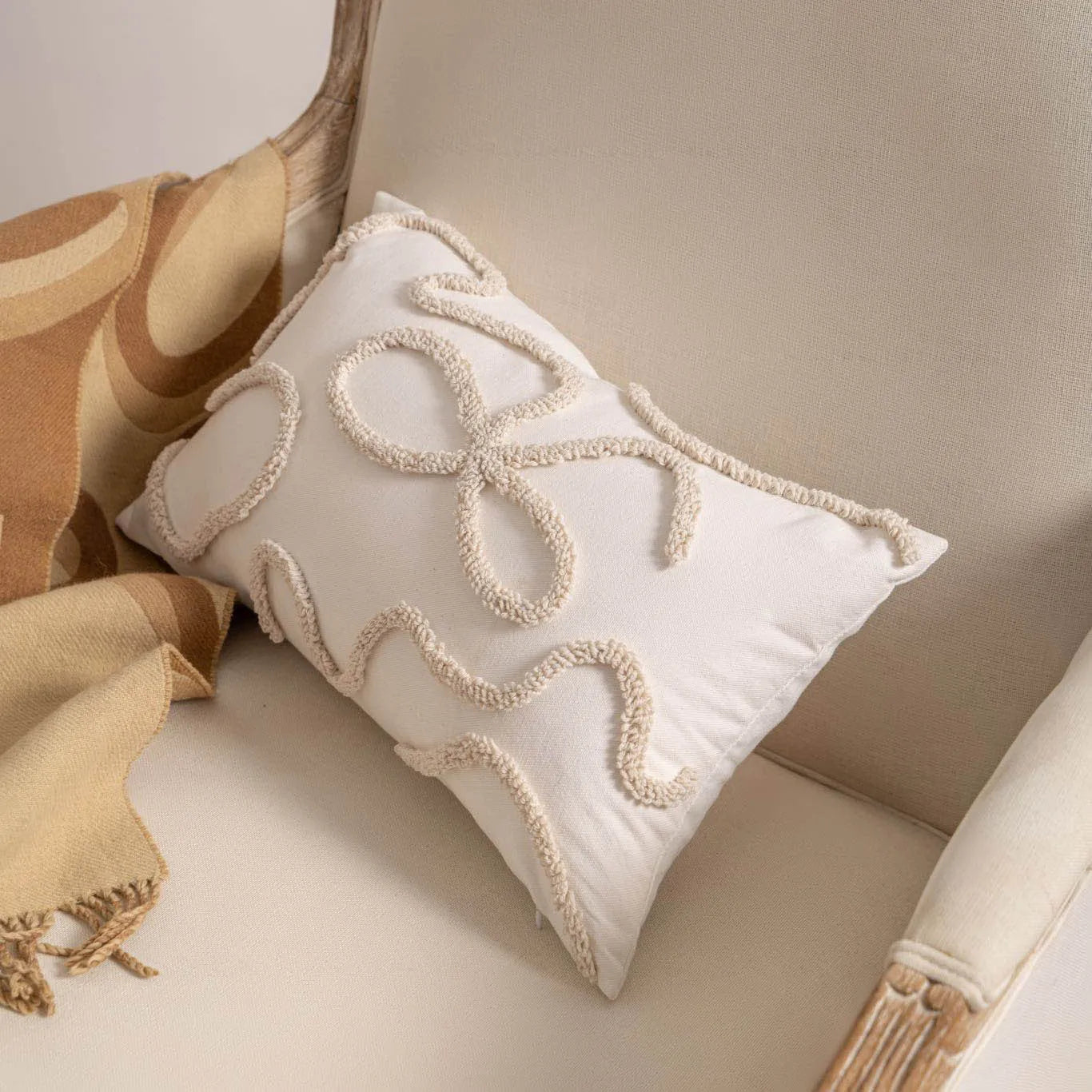 Knitted tassel pillow cover with striped pattern and bow design on home sofa