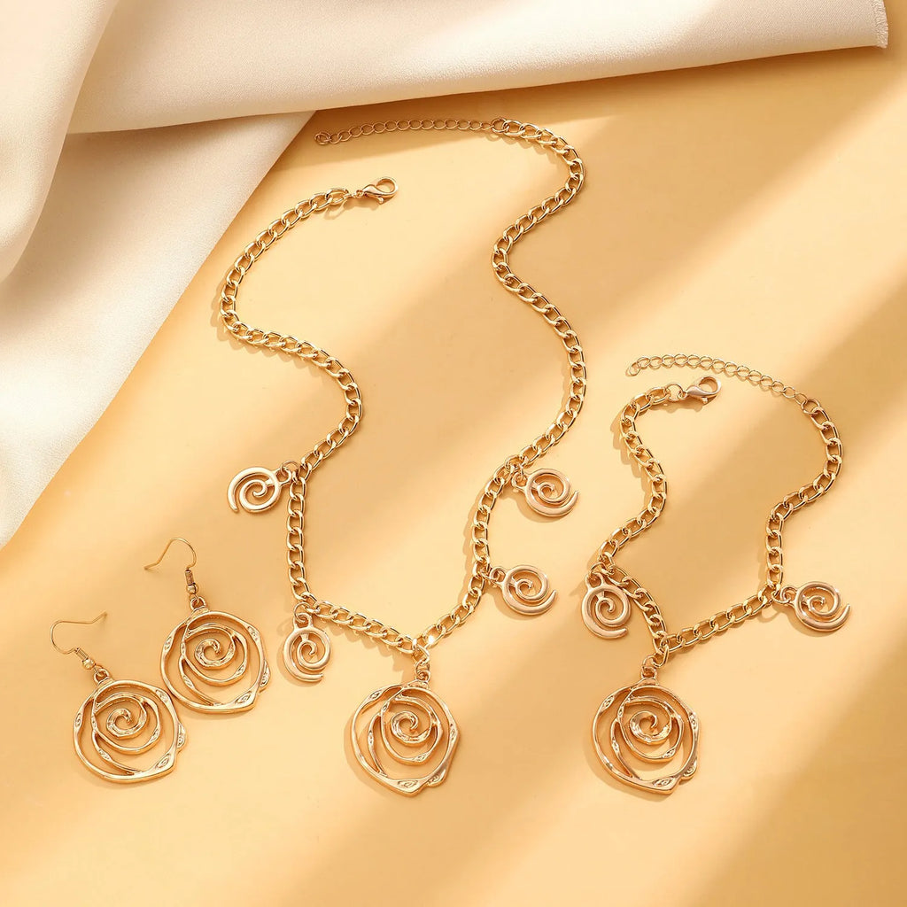 Gold or silver electroplated alloy jewellery set with spiral donut geometric shapes including necklace bracelet and ear hooks