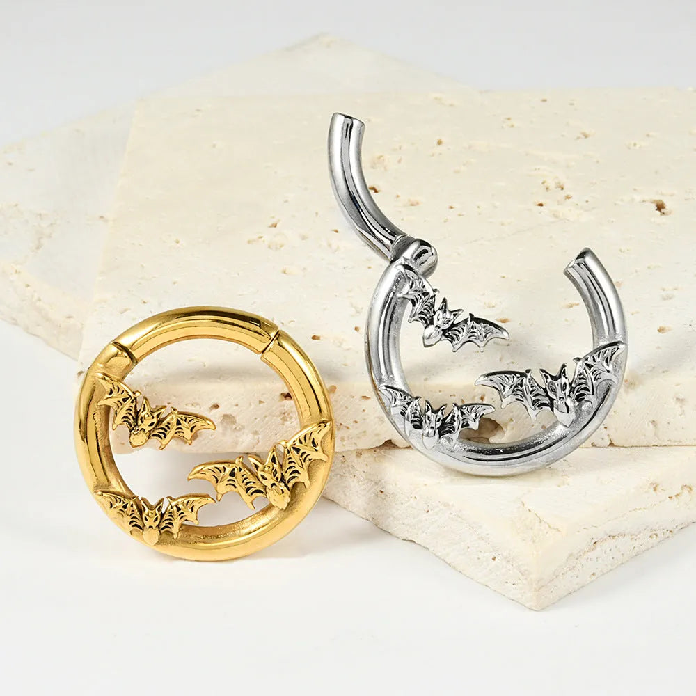 A pair of stainless steel fashion earrings with a geometric totem pattern in an electroplated finish.