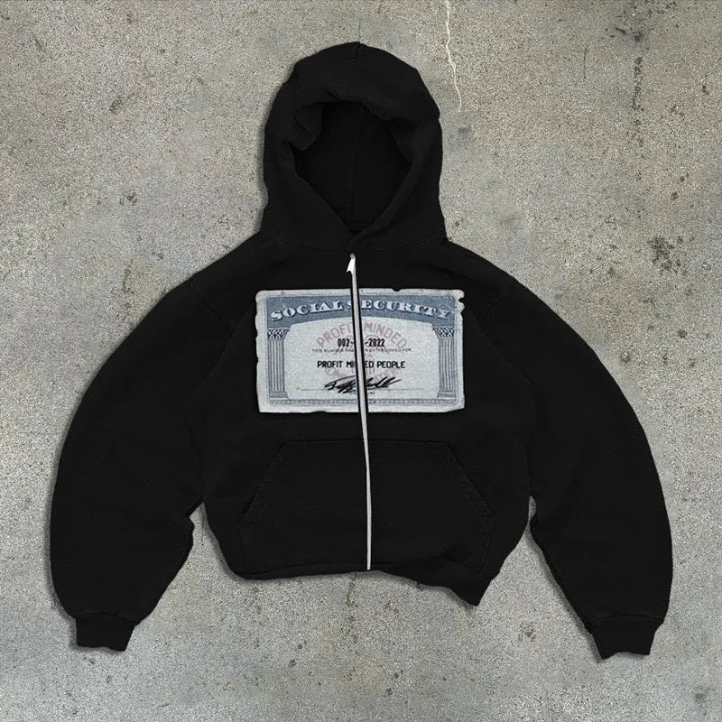 A man and woman wearing a loose fit black zip-up hoodie jacket with a hood and zip pockets.