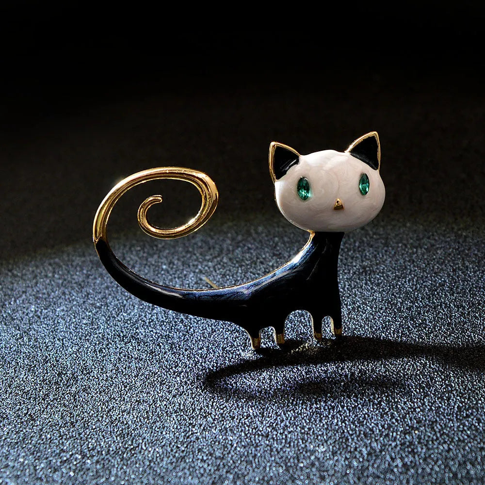 White and orange painted trailing up kitty brooch made from alloy metal
