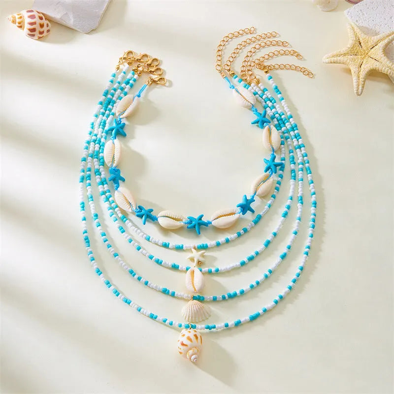 Women's multi-layer necklace set with starfish and shell bead pendants on adjustable chain