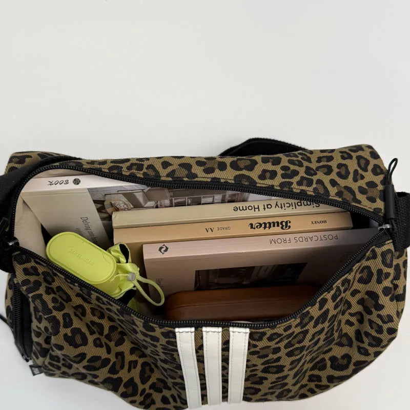 Sports-style cross-body messenger bag in leopard print pattern with decorative stitching details