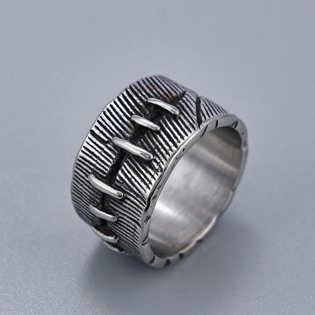 A geometric U-shaped dark punk double ring made from titanium steel in a retro colour, shown on a finger.