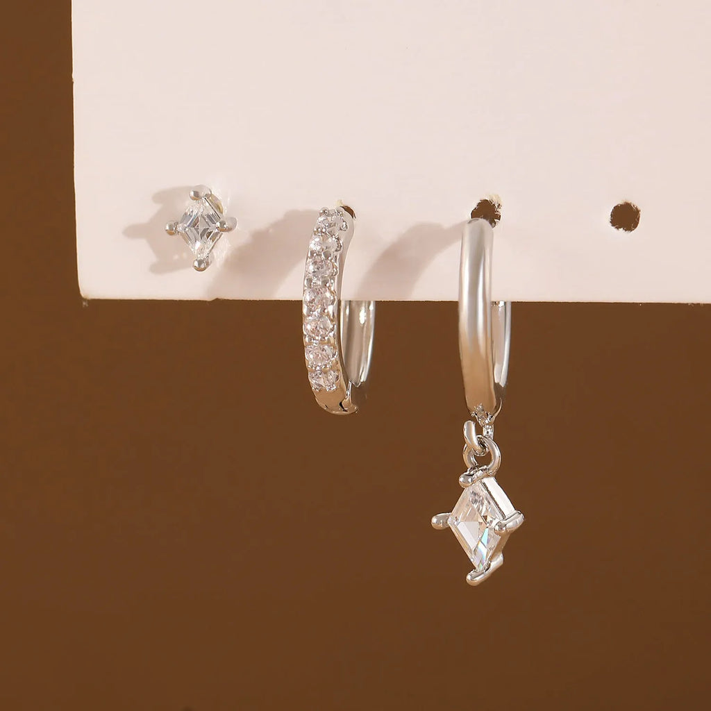 Geometric ladies earring set with zircon detailing in gold and silver options showing drop, stud, and clip-on pieces