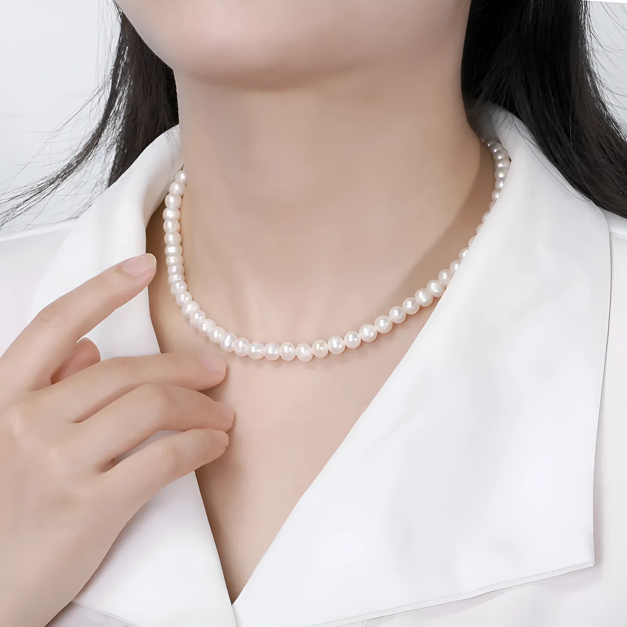 Close-up of a women's adjustable silver necklace with a single 6-7mm natural freshwater pearl pendant.