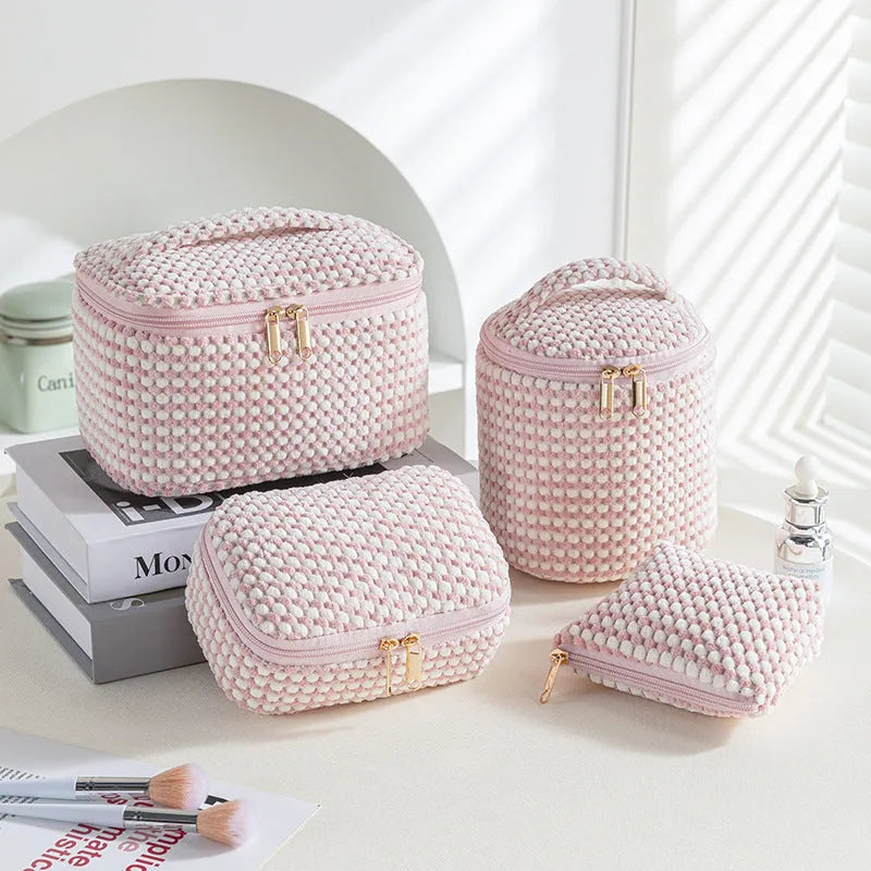 Four cube-shaped flannelette make-up bags in different colours: pink, khaki, pink dots, blue dots