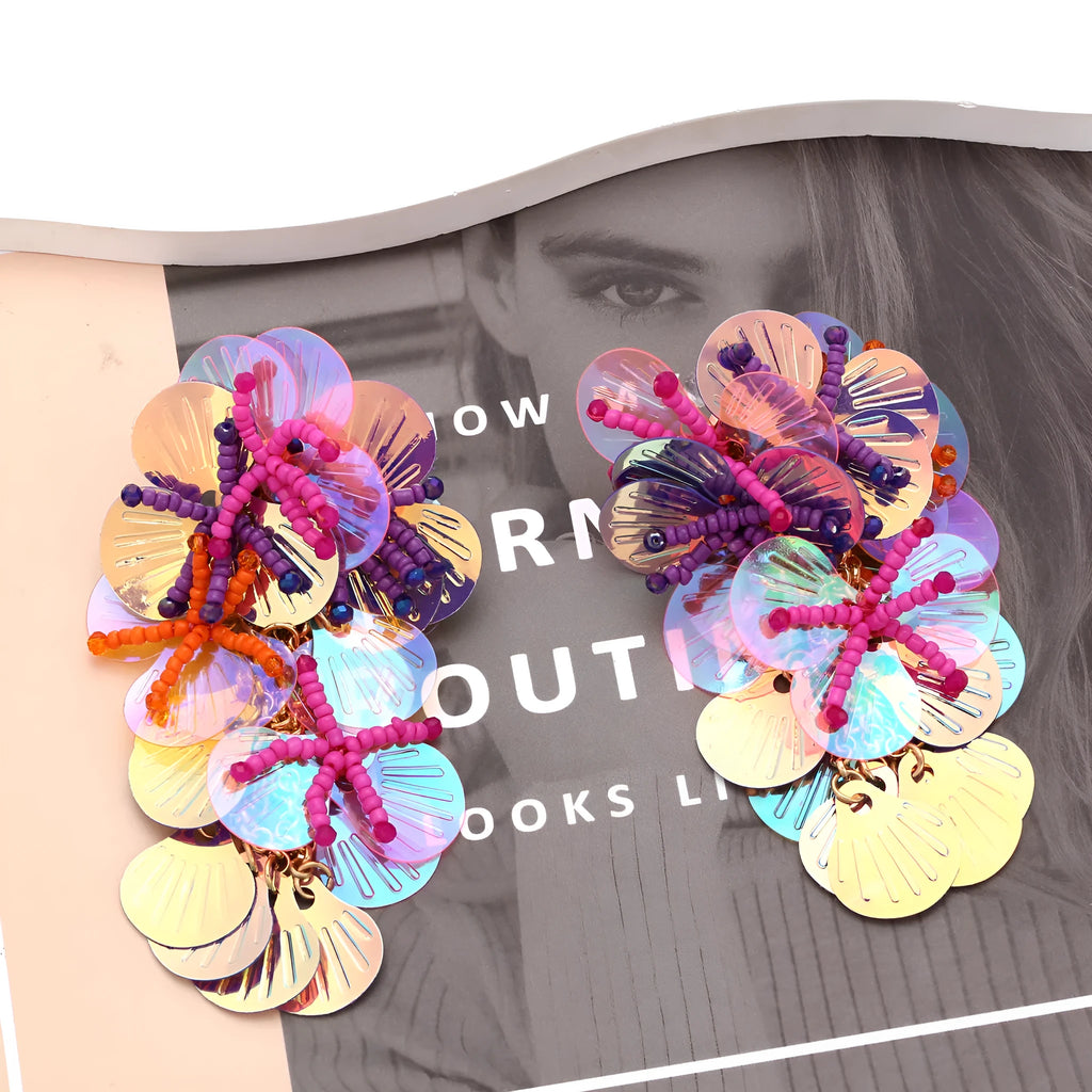 Handmade colourful bead flower and leaf drop earrings in an exaggerated oversized design.