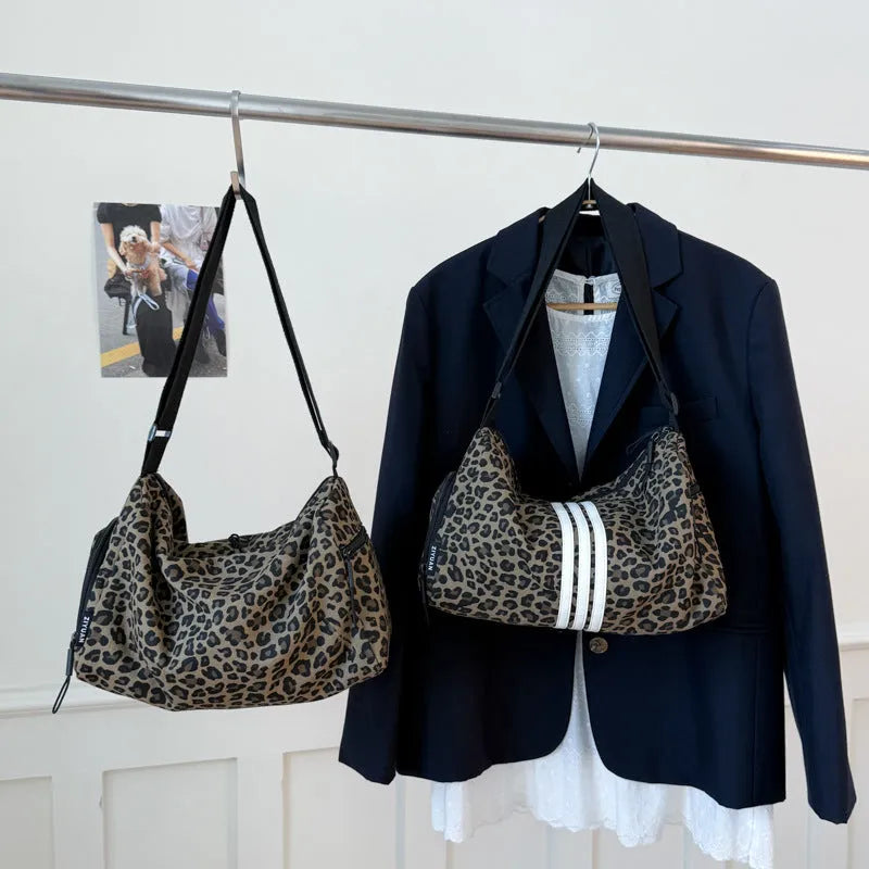 Sports-style cross-body messenger bag in leopard print pattern with decorative stitching details