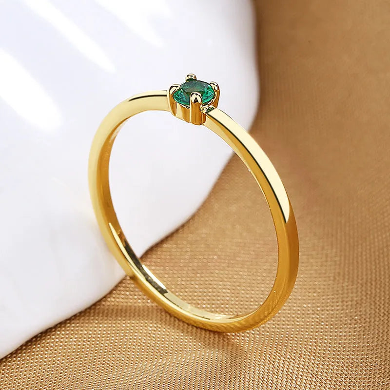 Copper geometric circle ring for women with a single diamond style in blue, green, red, or white on a size guide.