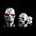 Retro skull stud earrings with red eye detailing and artificial gemstone inlay on alloy base