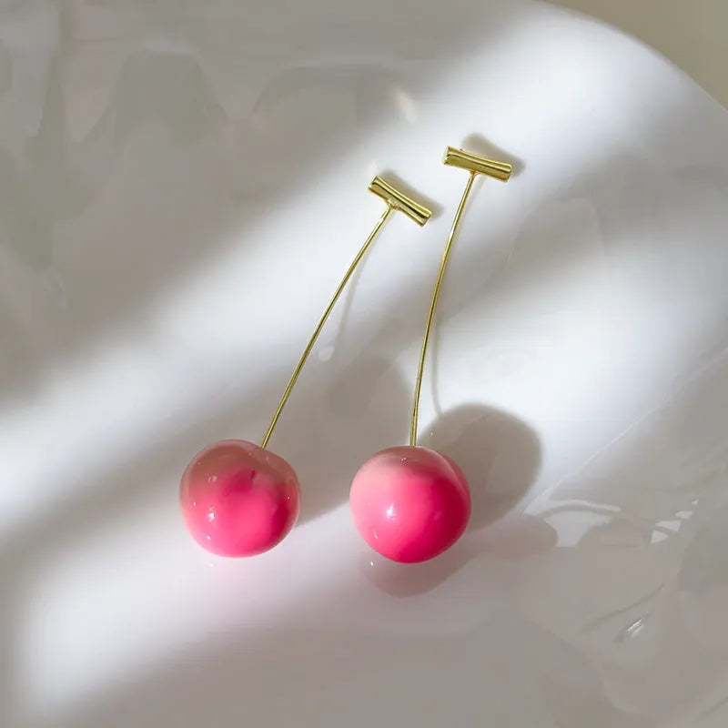 Women's acrylic peach fruit earrings in small and large size options with copper findings