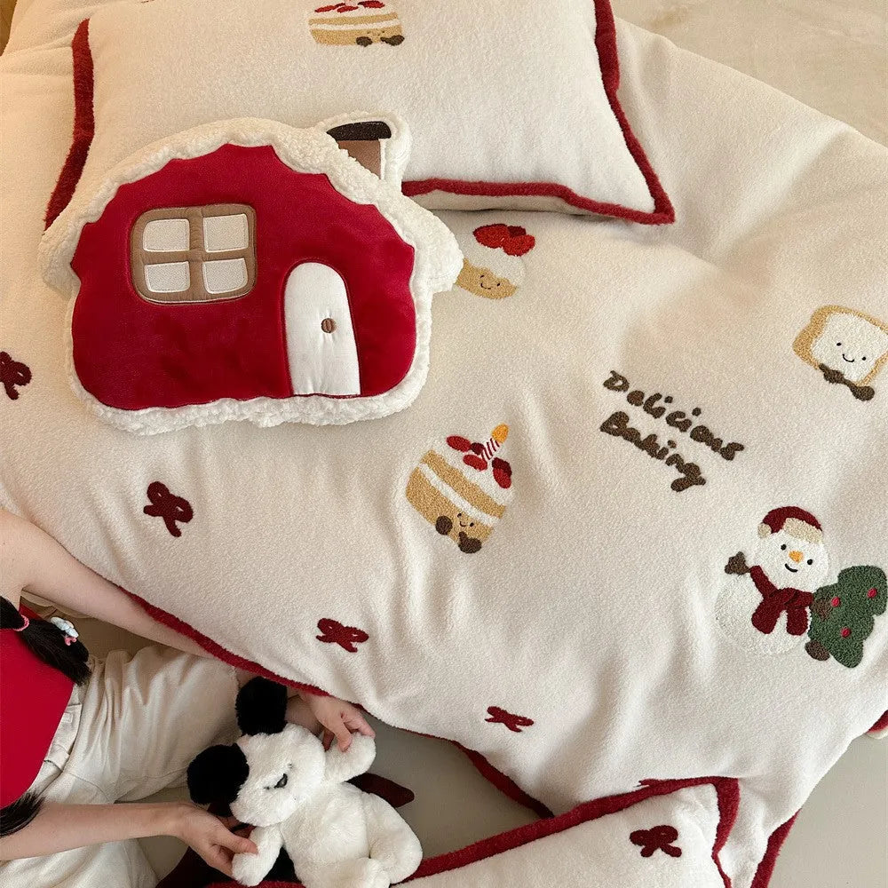 Winter Christmas cartoon patterned bedding four-piece set showing duvet cover, sheet, and pillowcases in pastel colours.