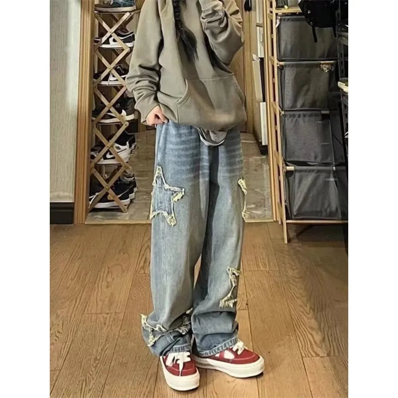 Blue women's high-waist straight-leg jeans laid flat, showing denim texture and button fly.
