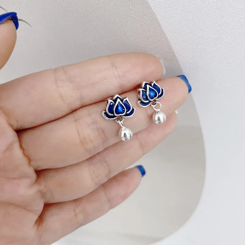 A pair of blue lotus ear studs with a seedpod and tassel design made from alloy.