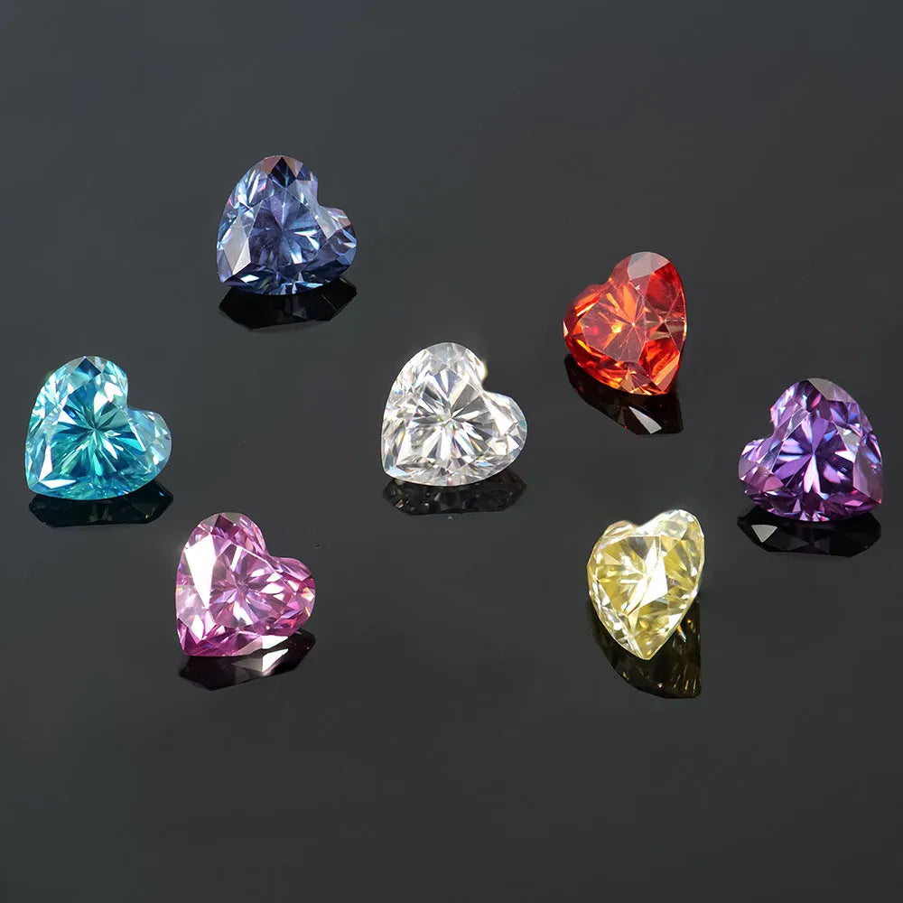 A colourful heart-shaped moissanite gemstone in various sizes and shades including lemon yellow, pink and sapphire blue.