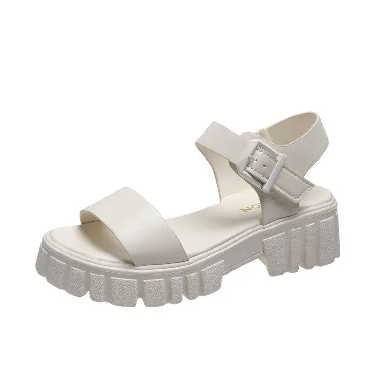 Women's beige peep toe platform sandals with an ankle-strap buckle on a wooden floor.