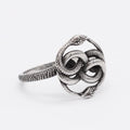 Steel-coloured titanium steel retro ring with a detailed double snake design on a finger.