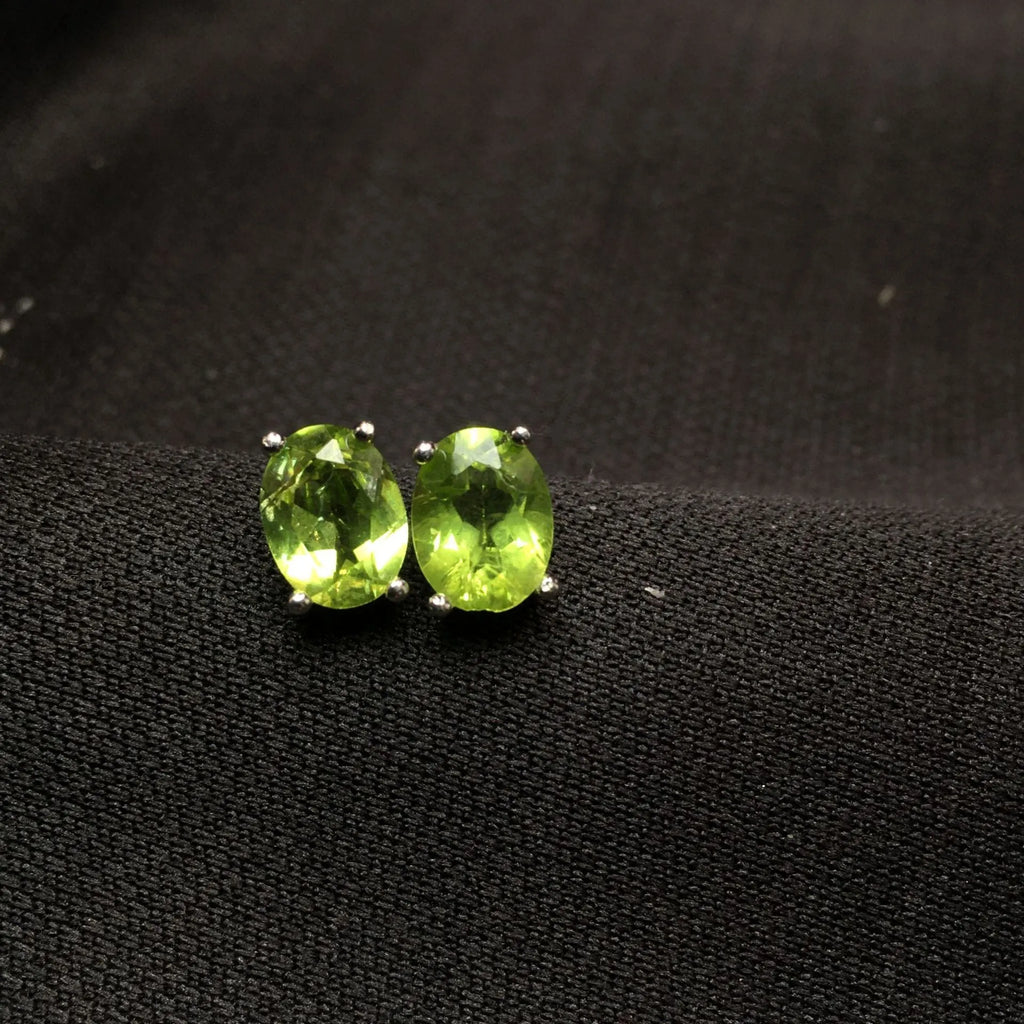 Pair of natural grass green olivine stud earrings with elliptical 6 × 8mm stones in S925 sterling silver settings
