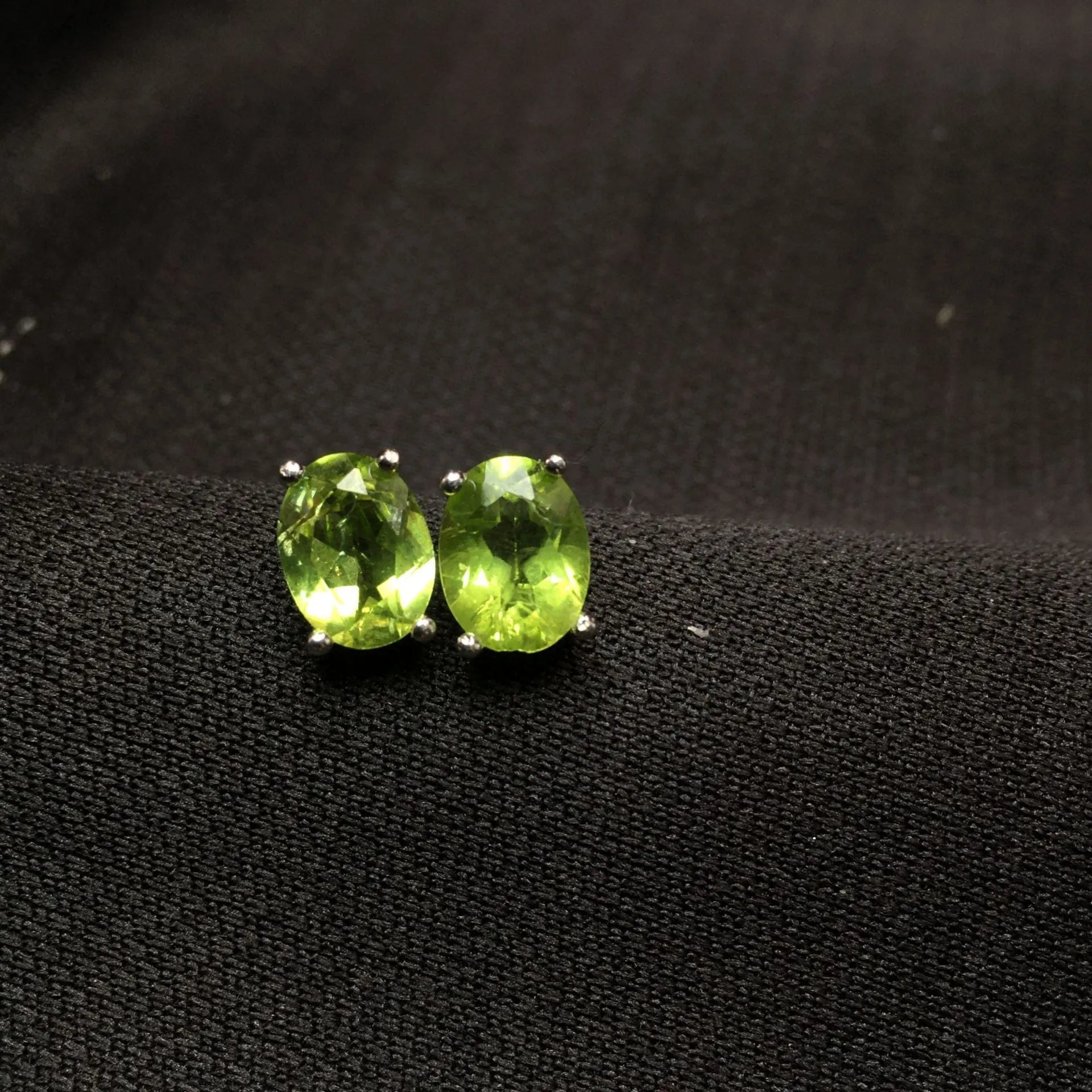 Pair of natural grass green olivine stud earrings with elliptical 6 × 8mm stones in S925 sterling silver settings