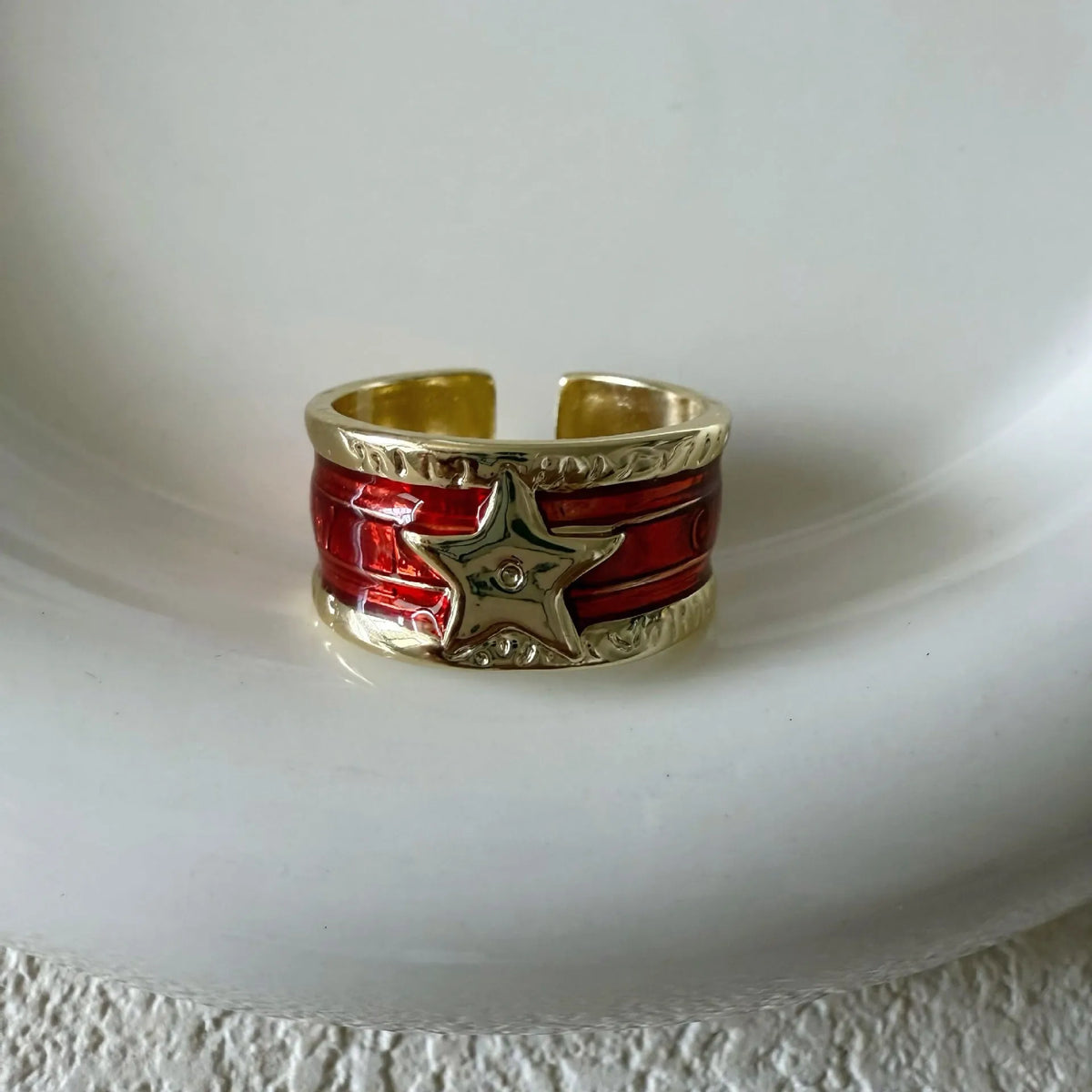 Adjustable geometric drop oil ring for women in distressed copper, shown in multiple colour options.