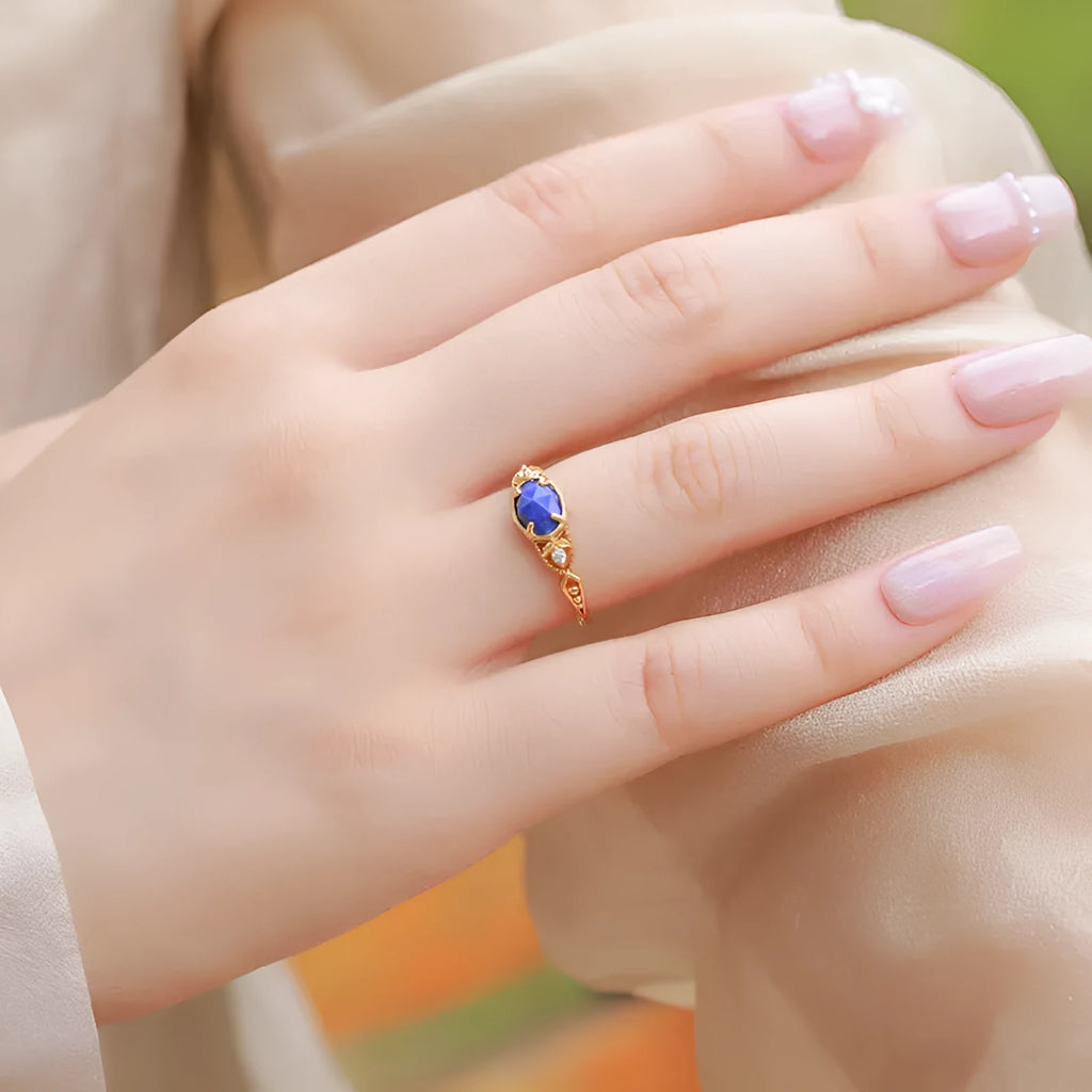Oval geometric women's ring with a blue lapis lazuli stone in a silver alloy Japanese-style setting.