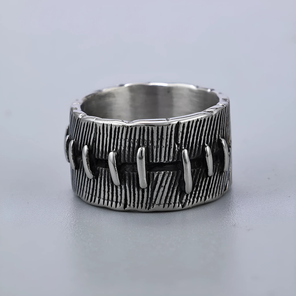 A geometric U-shaped dark punk double ring made from titanium steel in a retro colour, shown on a finger.