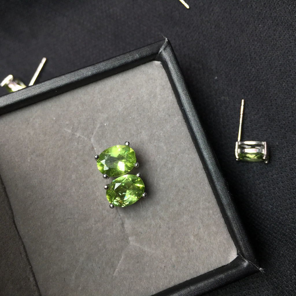 Pair of natural grass green olivine stud earrings with elliptical 6 × 8mm stones in S925 sterling silver settings
