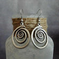 Geometric spiral distressed silver alloy earrings measuring 2.6 by 5 centimetres