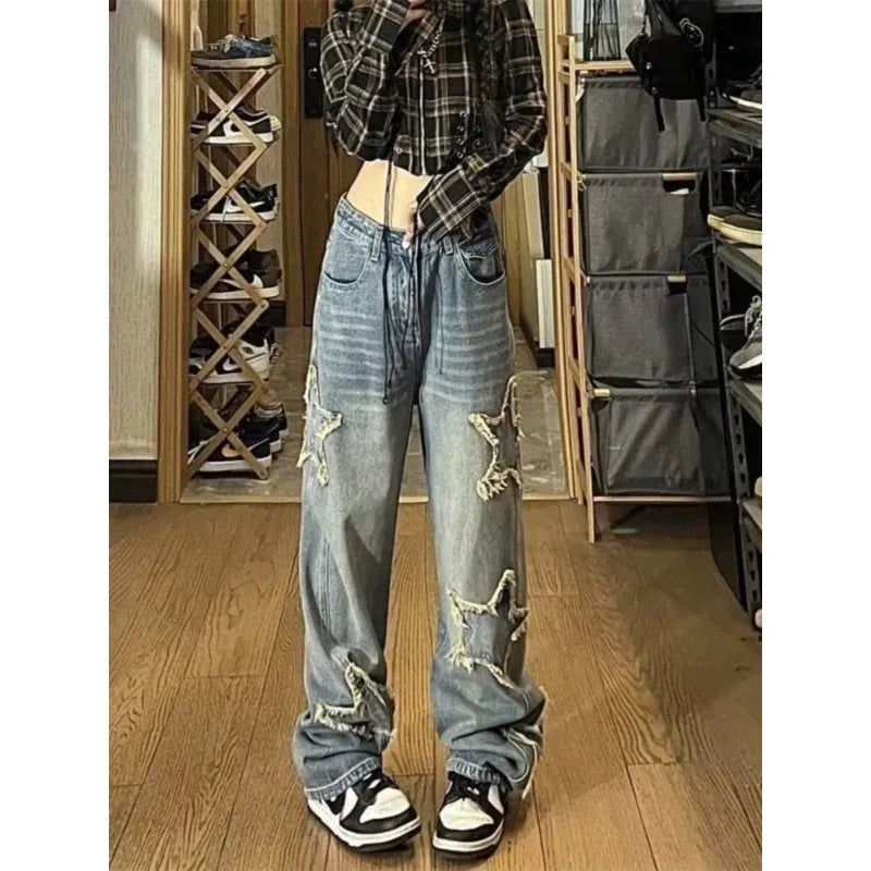 Blue women's high-waist straight-leg jeans laid flat, showing denim texture and button fly.