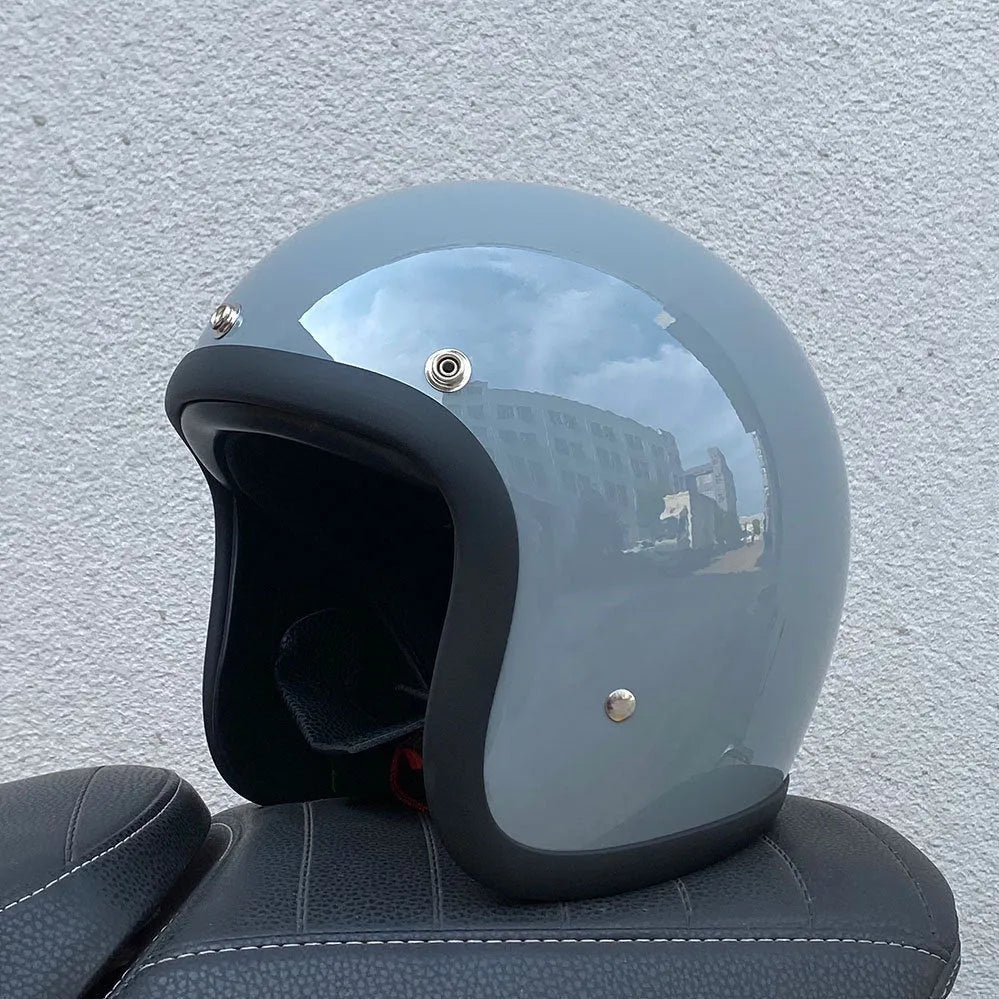 Retro-style half-shell motorcycle helmet in fibreglass, shown in a cement grey colour option.