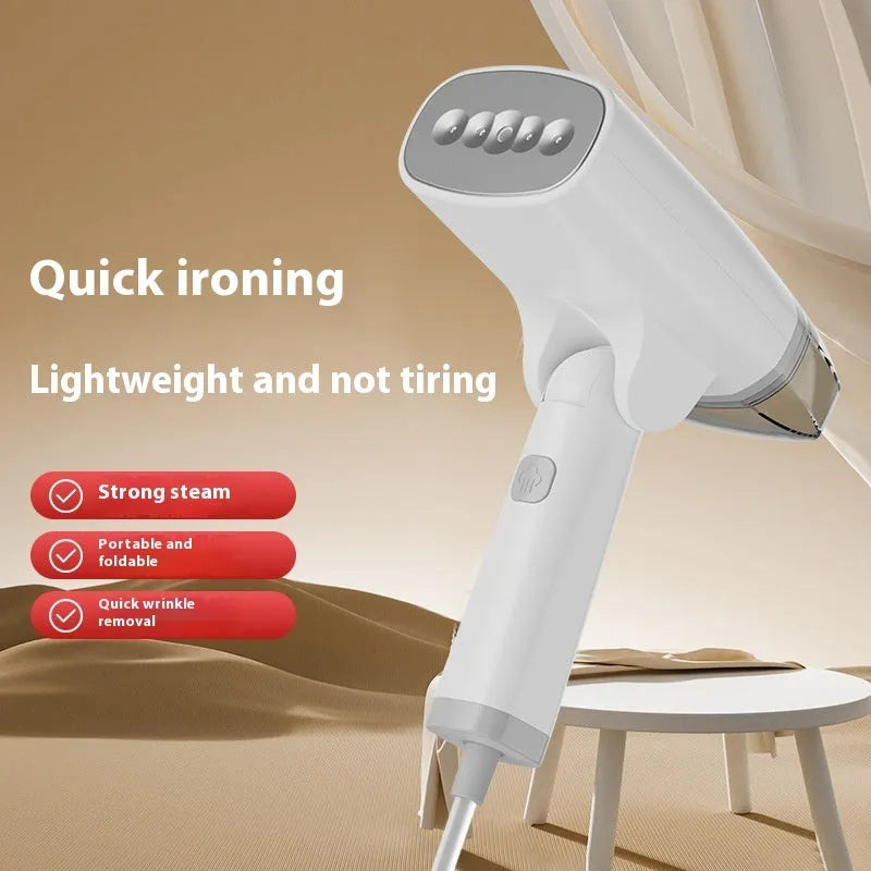 Blue and white handheld garment steamer with hanging iron attachment on wooden surface