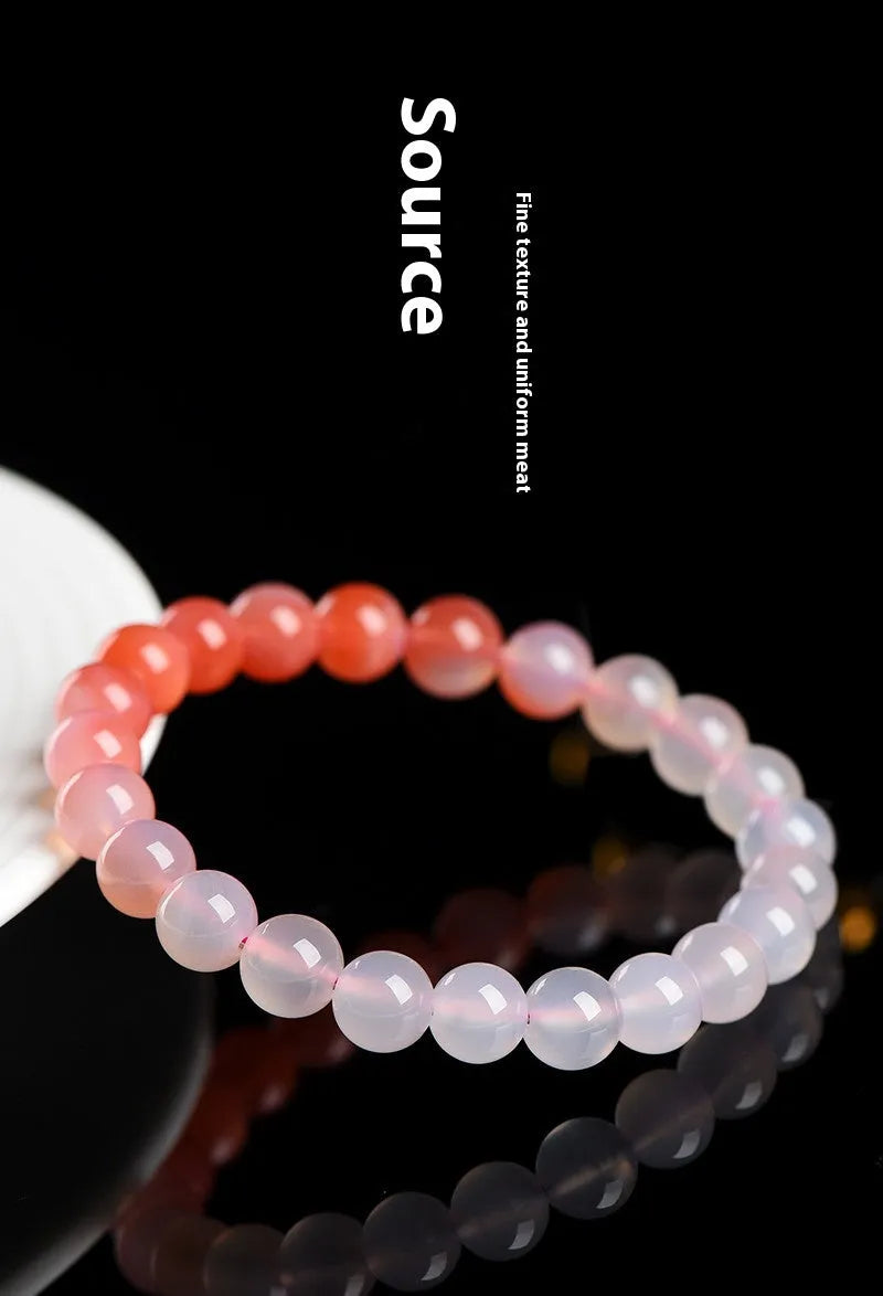 Natural gradient Yanyuan agate bracelet with geometric beads on a wrist, showing colour variation.