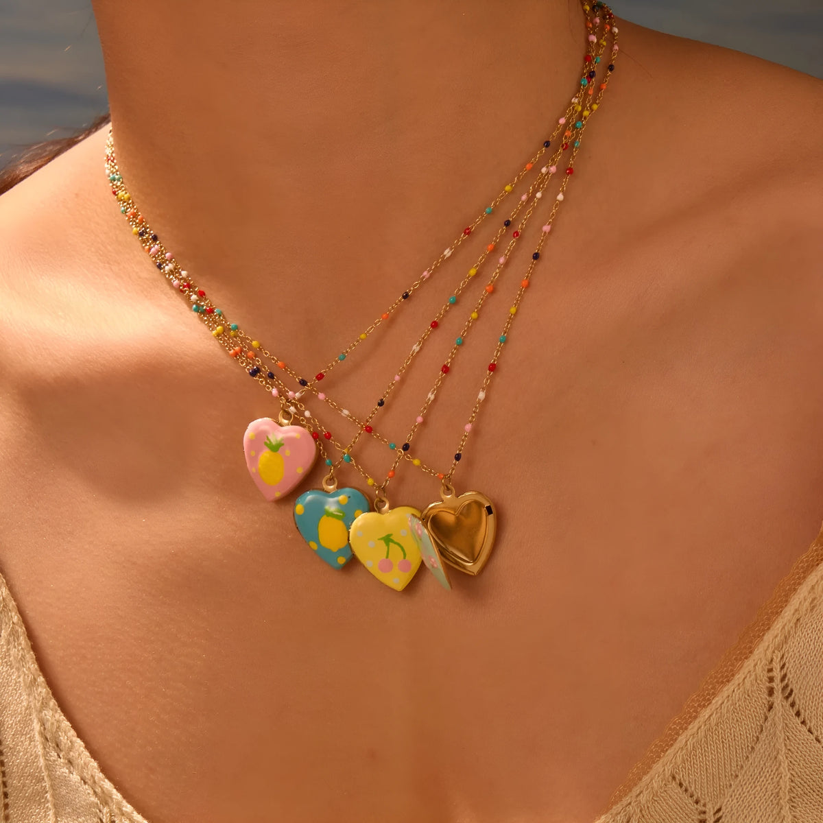 Gold-plated stainless steel necklace with heart-shaped fruit pendant on adjustable chain