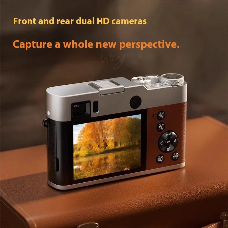 Black 5K HD digital camera with front and rear lenses, 2.88-inch screen, and optical viewfinder on a table with accessories.
