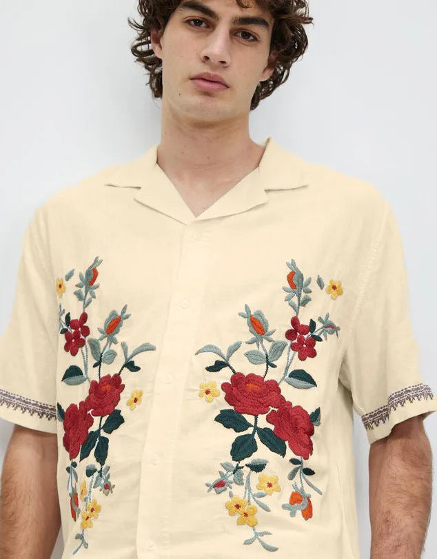 Apricot colour men's shirt with floral print pattern and lapel collar on white background
