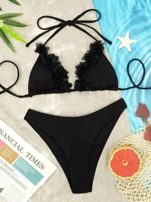 Black women's two-piece bikini swimsuit with gathered design on a mannequin