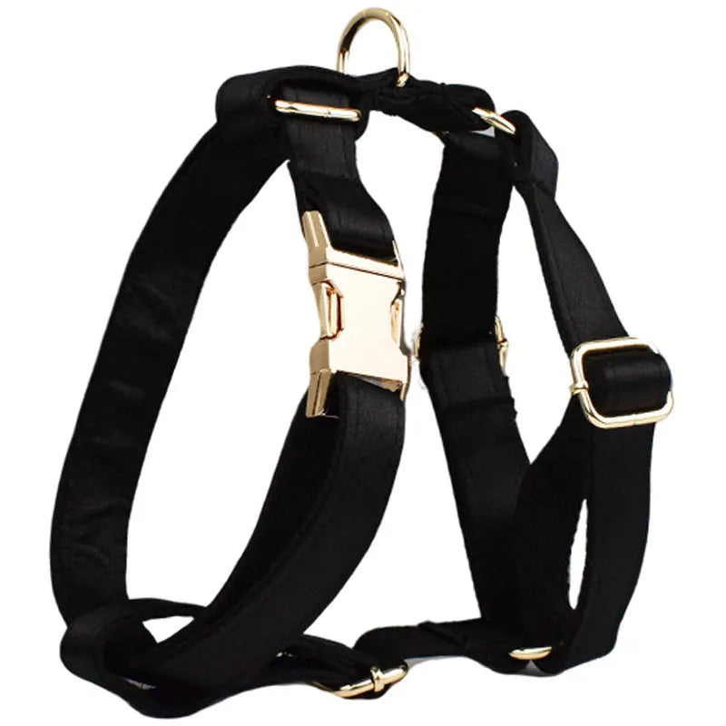 A cloth dog collar, matching leash, decorative bow, and dog vest set laid out flat, showing the coordinated design.