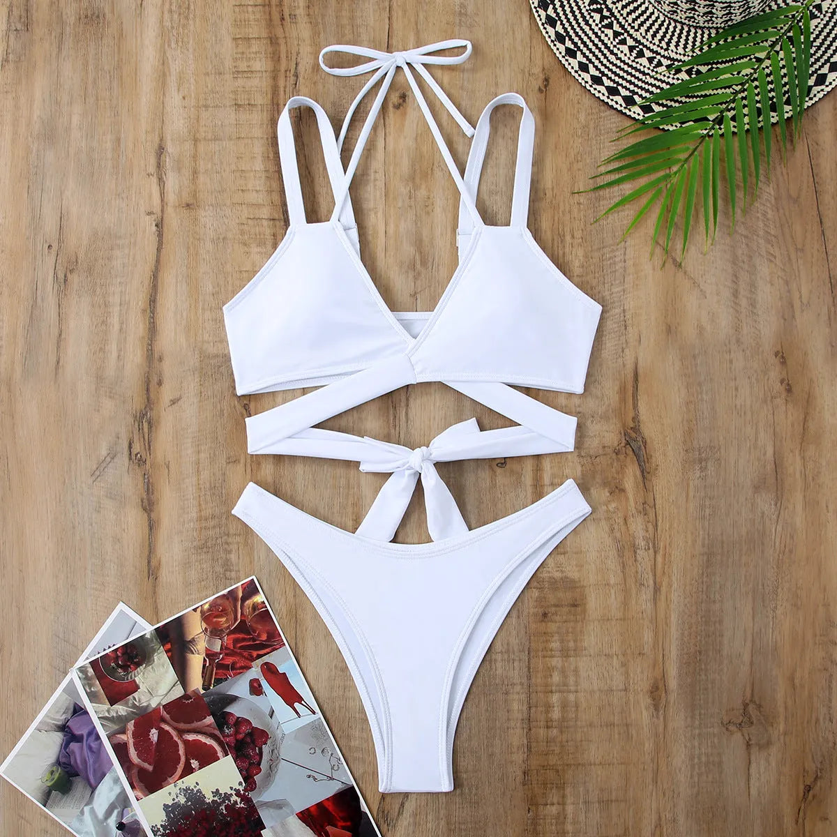 Women's solid colour strap bikini swimsuit on a hanger, showing the briefs style in one of the five available colours.