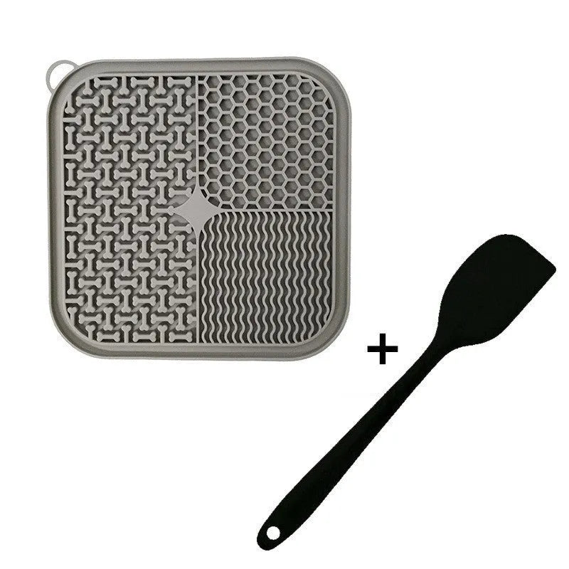 Blue silicone dog lick mat with textured pattern and suction cups on a table.