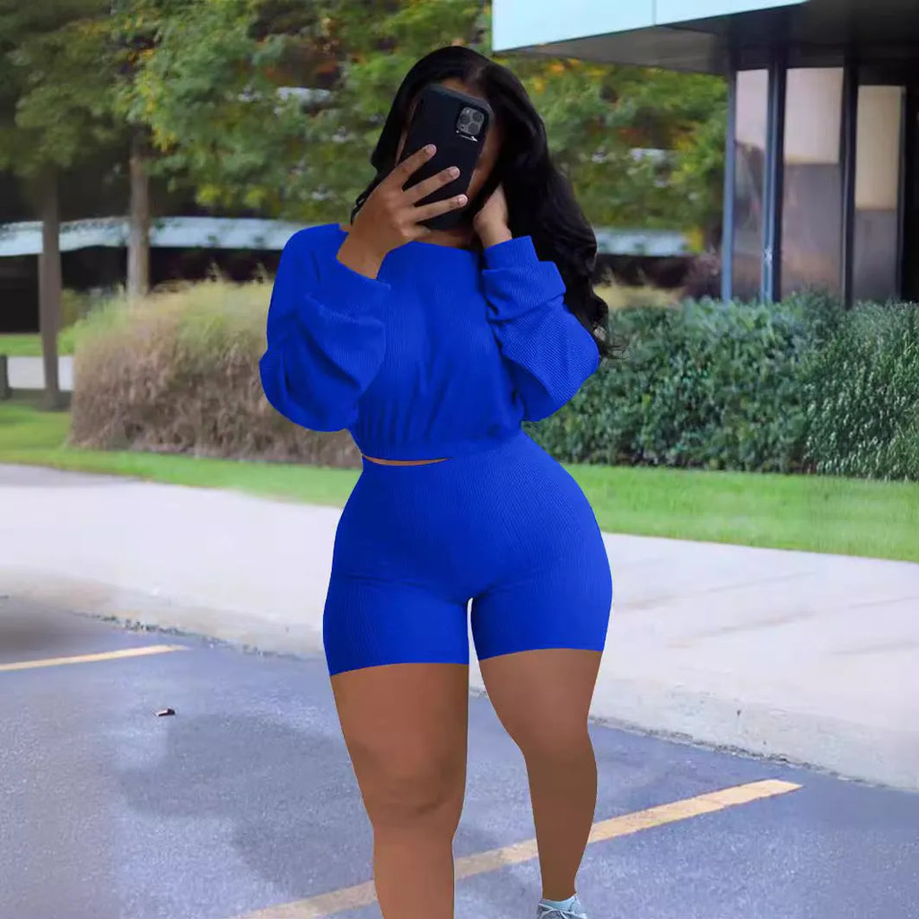 Women's solid colour off-the-shoulder long sleeve top and matching shorts two-piece set.
