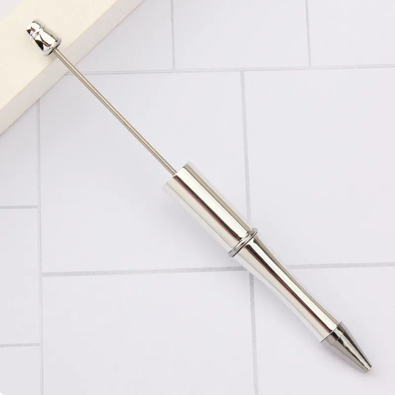 Ballpoint pen with colourful spinning plastic beads on barrel, shown in a gradient purple finish.