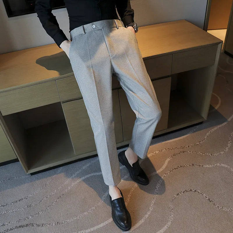 Straight leg brown corduroy trousers for men laid flat, showing texture and elastic waistband.